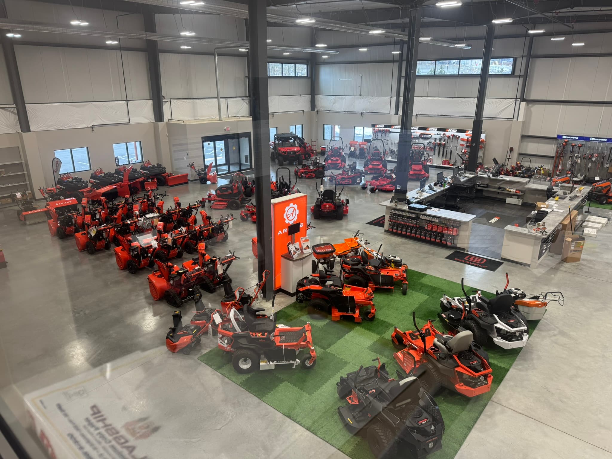 Interior showroom displaying outdoor power equipment at the Boston Lawnmower dealership in Westborough, Massachusetts