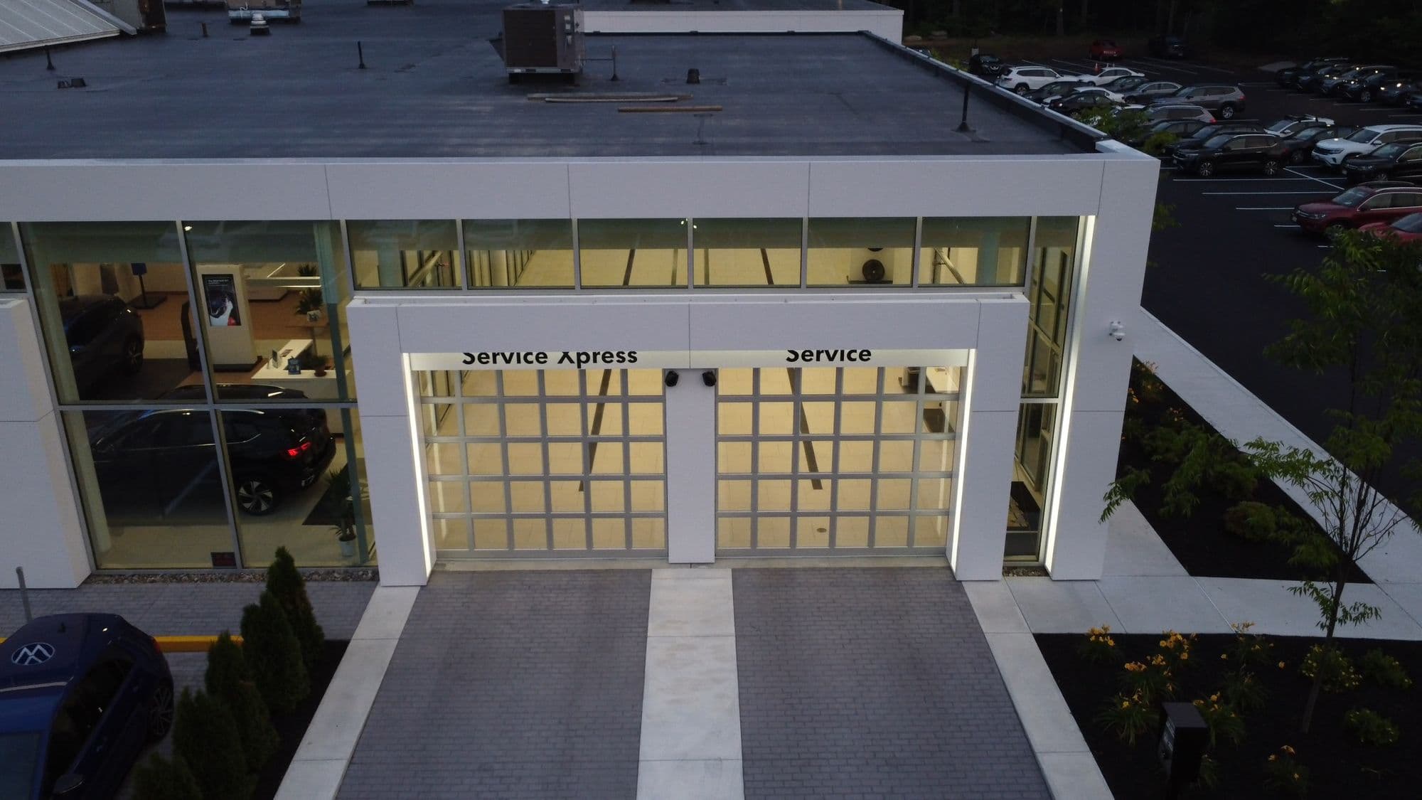 Volvo dealership service bay with vehicle lifts, service equipment, and open workspace designed for automotive maintenance
